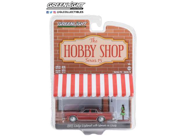 PRE-ORD3R GreenLight Modeliukas 1983 Dodge Diplomat with Woman in Dress *The Hobby Shop Series 15*, red