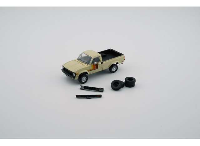 PRE-ORD3R BM Creations Modeliukas Toyota Hilux, ivory left hand drive with extra set of wheels and bumpers